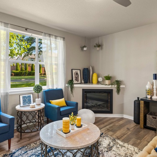 Model Home Living Room fireplace in spacious living room with large windows