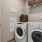 washer and dryer with shelves above